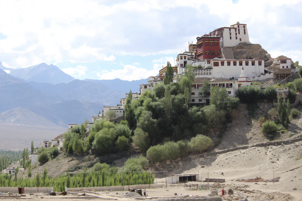 A striking side profile of Thiksey Monastery, capturing the grandeur of its structure nestled within the serene Ladakhi mountains.
